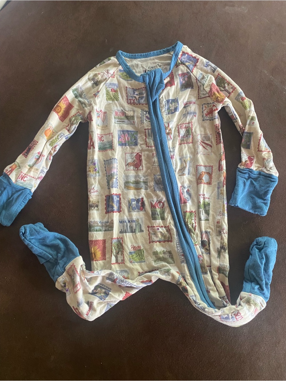 Little Crowns and Capes Footed One-Piece with Blue Trim and Zip Closure